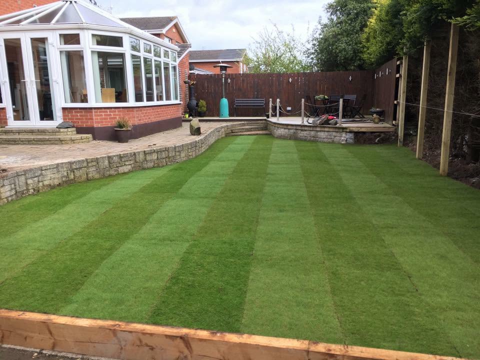 Artificial-grass lawn beside a raised paved area