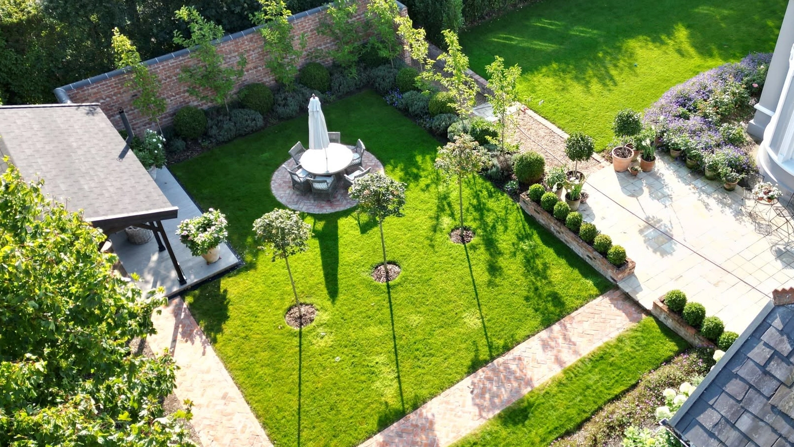 Overhead view of a garden with intersecting paths, lawn and patio
