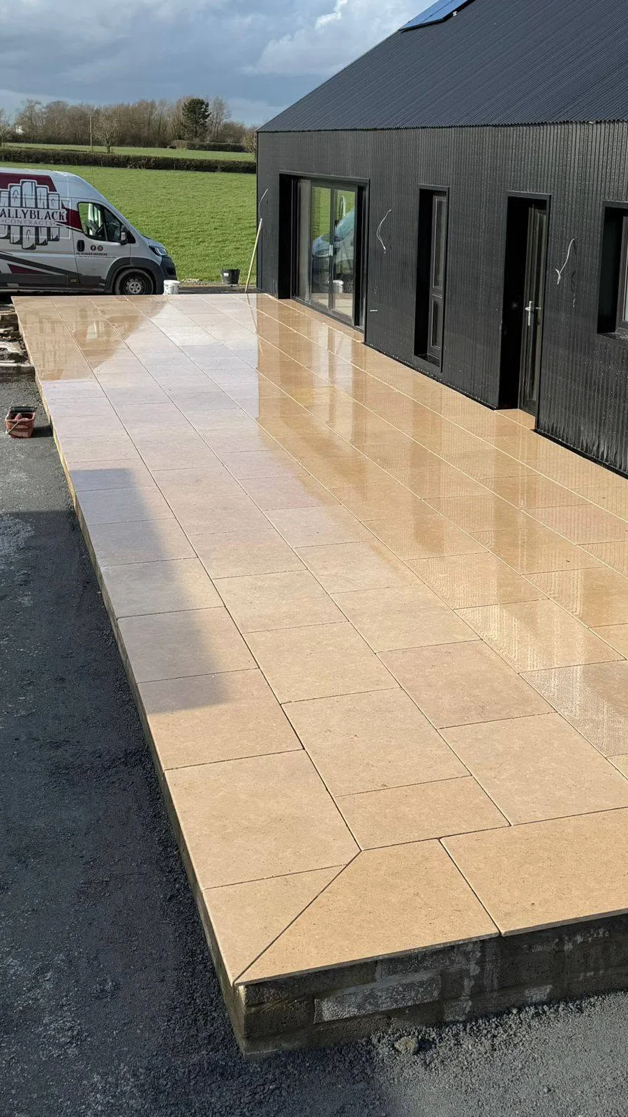 Paved terrace extending along the side of the building