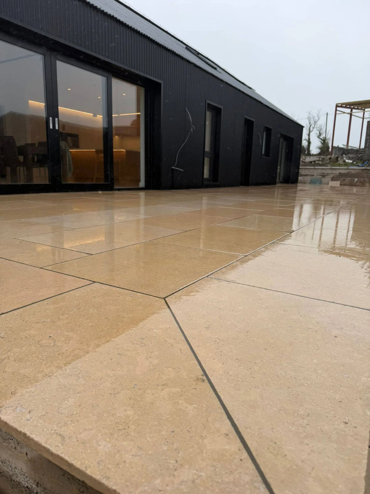 Close view of paving joints beside glazed doors