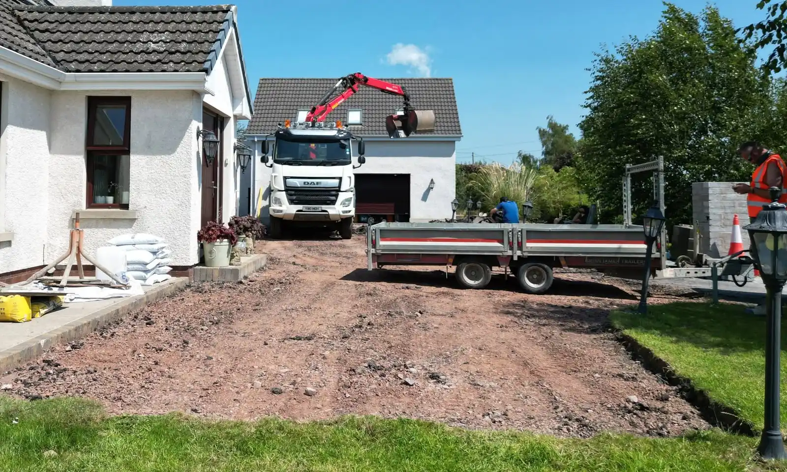 Prepared driveway surface between the house and lawn
