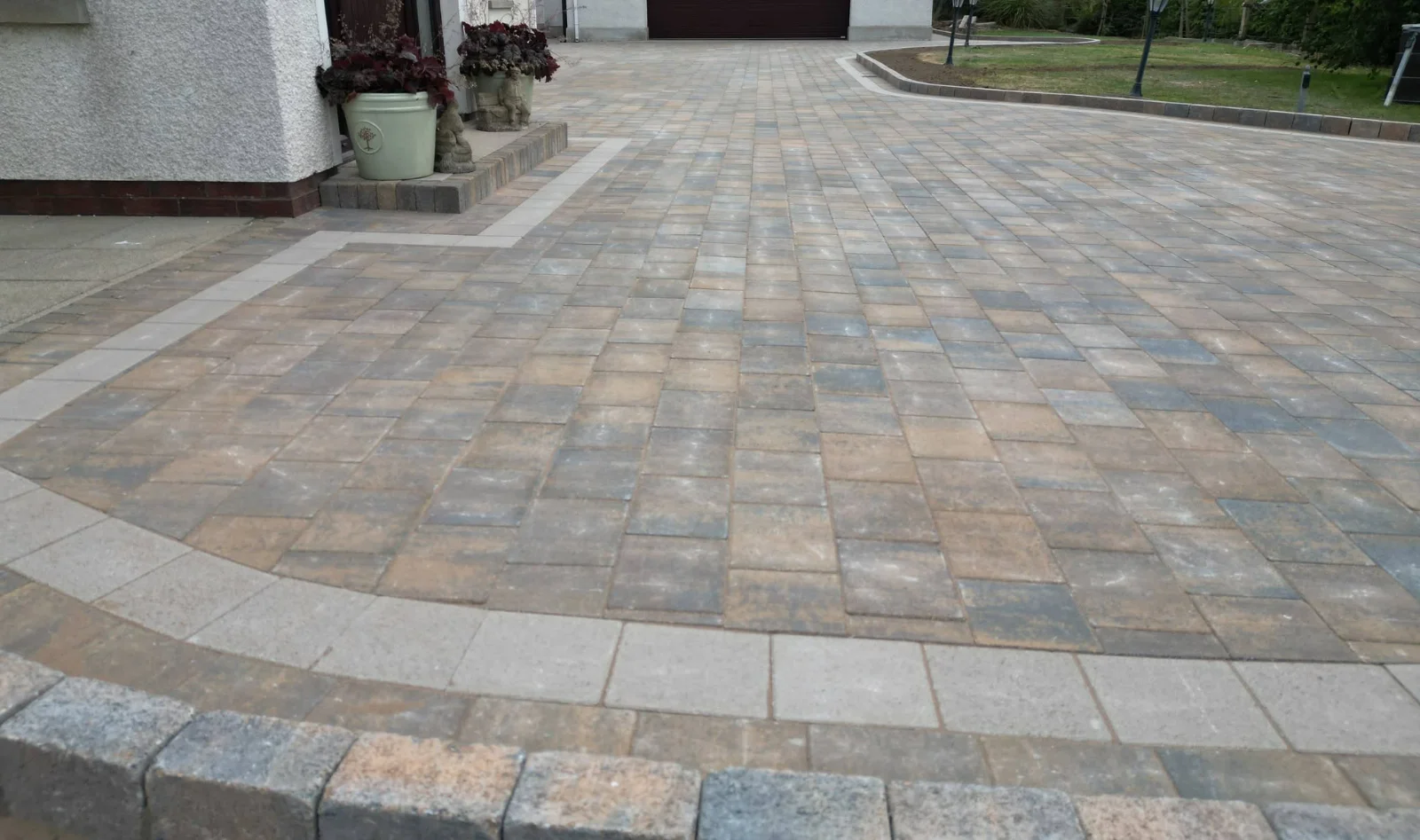 Finished driveway paving with a contrasting curved border