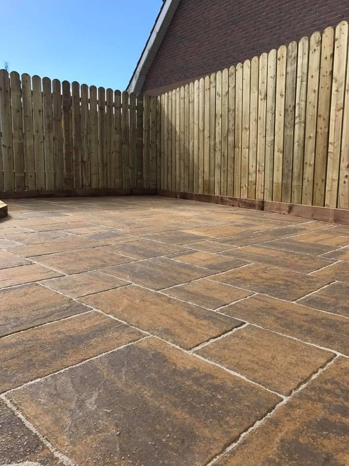 Paved patio with timber boundary fencing