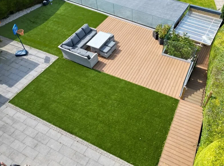 Overhead view of artificial-grass lawn areas beside decking and paving