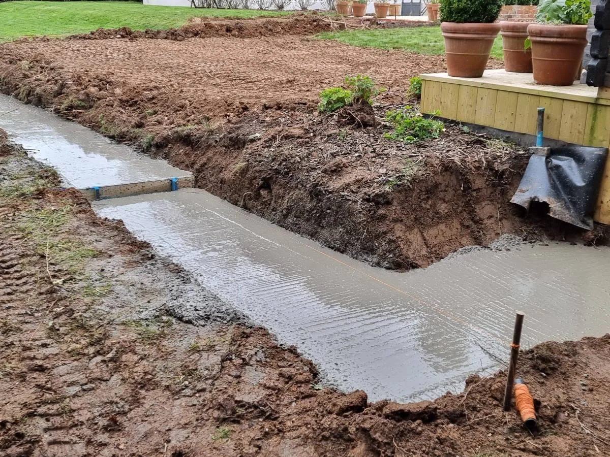Ground preparation beside an existing garden structure